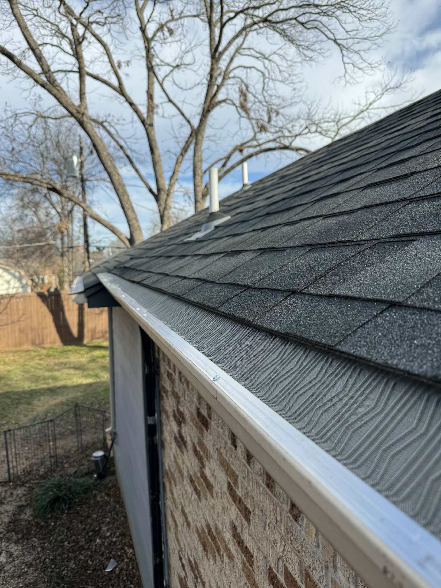 Leaf guard installed on a brick DFW home gutter, different project